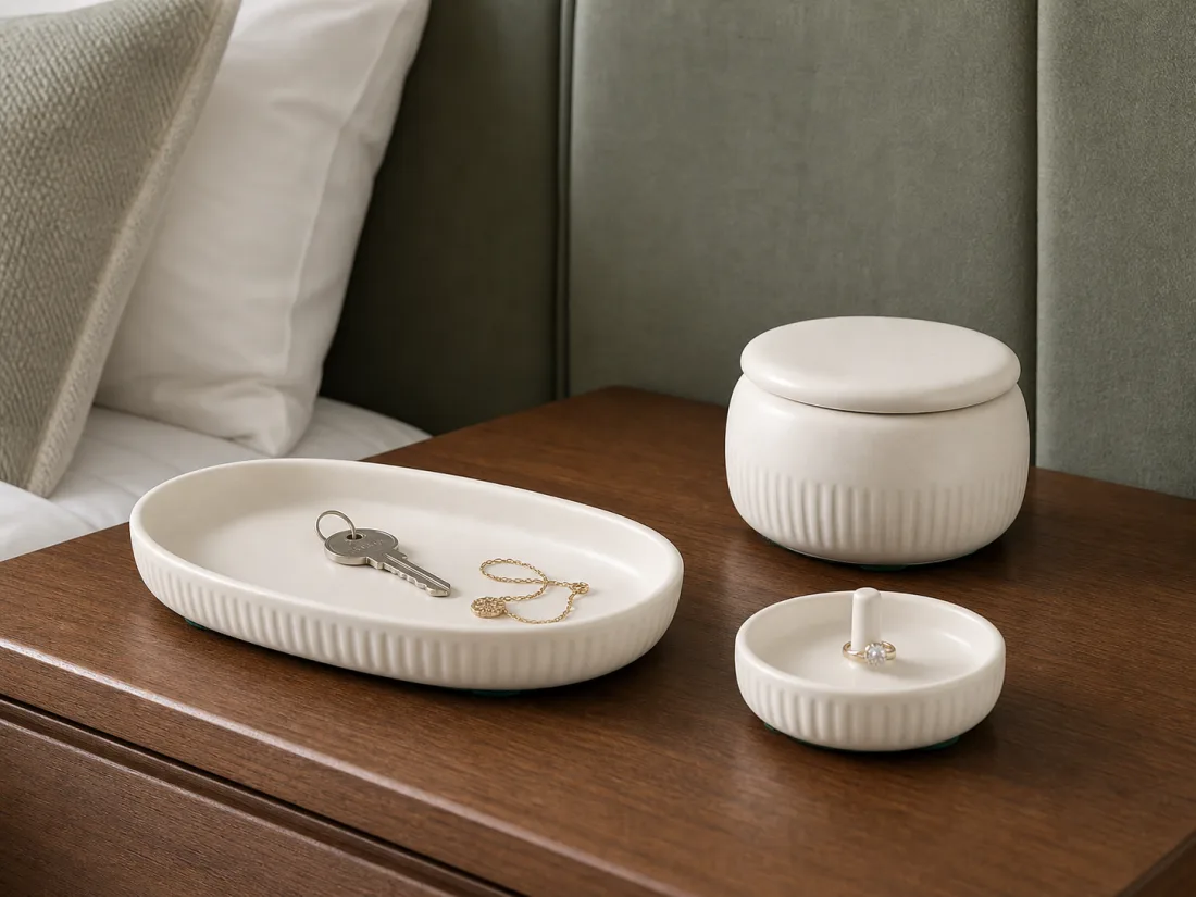 Porcelain tray, lidded jar, and small dish on a hotel bedside table