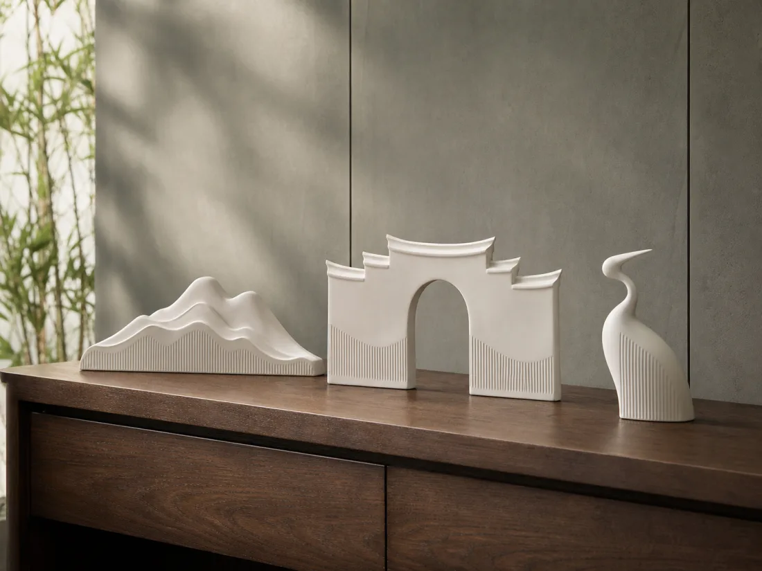 White sculptural porcelain decorative objects on a console